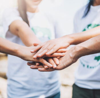 close-up-people-volunteer-teamwork-putting-finger-star-shapehands-togetherstack-handsunity-teamwork-world-environment-day