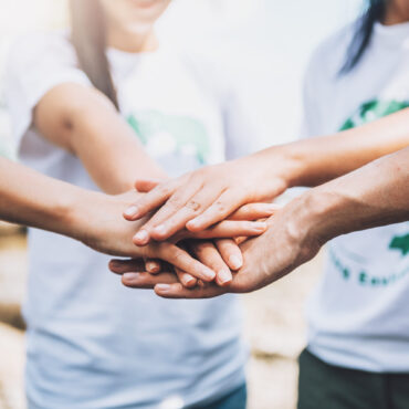 close-up-people-volunteer-teamwork-putting-finger-star-shapehands-togetherstack-handsunity-teamwork-world-environment-day
